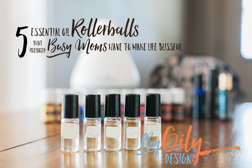 Row of 5 clear glass roller bottles with essential oils for kids. behind is a row of premium starter kit oils, diffuser, more rollers and a small bag.