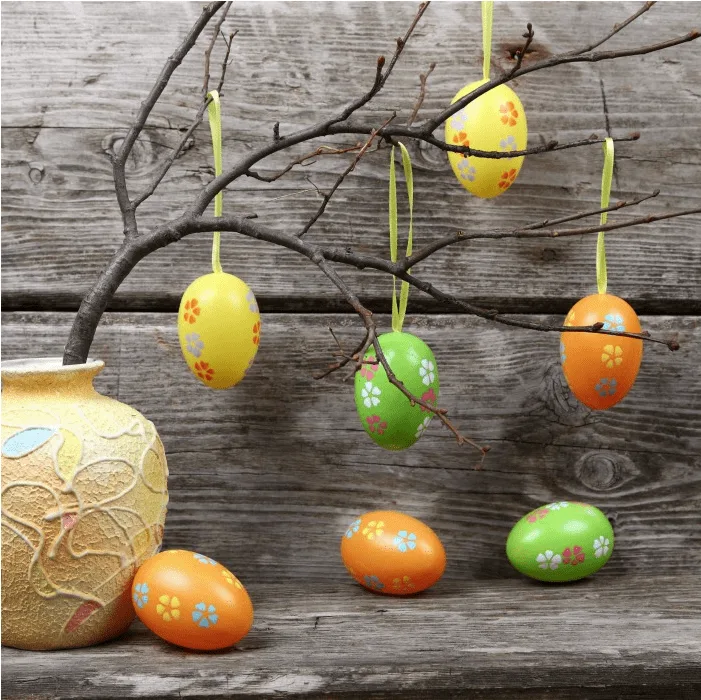 tree branch with plastic decorated Easter eggs