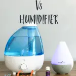 essential oil diffuser and humidifier on a table with a bottle of lavender oil