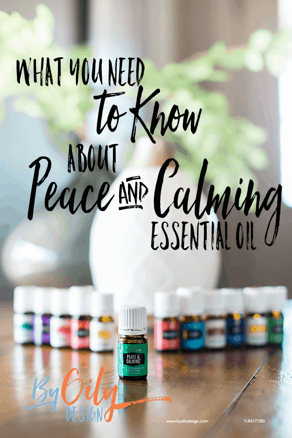 bottle of peace and calming essential oil with 11 other young living essential oils and a desert mist diffuser behind the oils. All are on a wooden table by a window with a plant