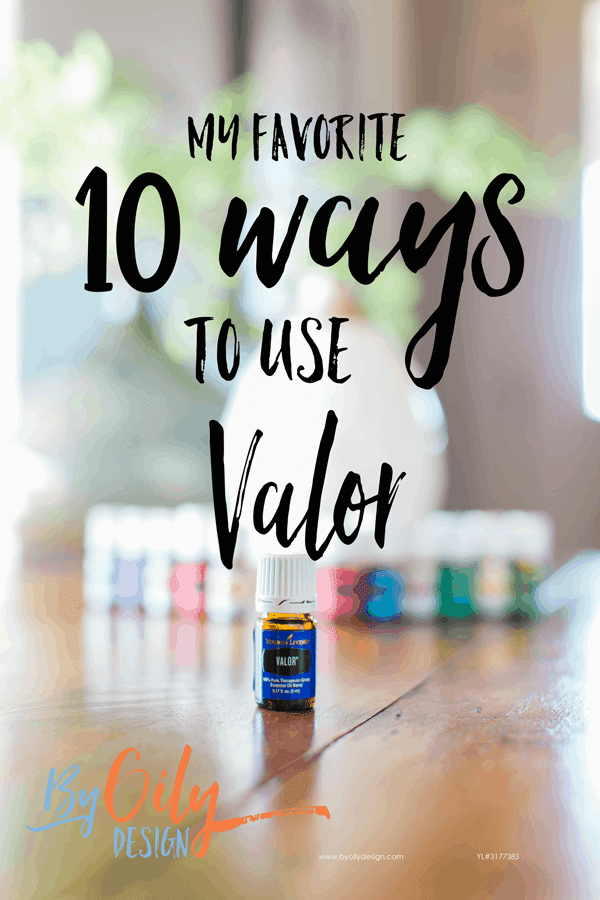 bottle of Valor essential oil with 11 other young living essential oils and a desert mist diffuser behind the oils. All are on a wooden table by a window with a plant