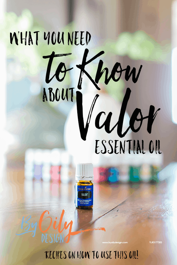 bottle of Valor essential oil with 11 other young living essential oils and a desert mist diffuser behind the oils. All are on a wooden table by a window with a plant