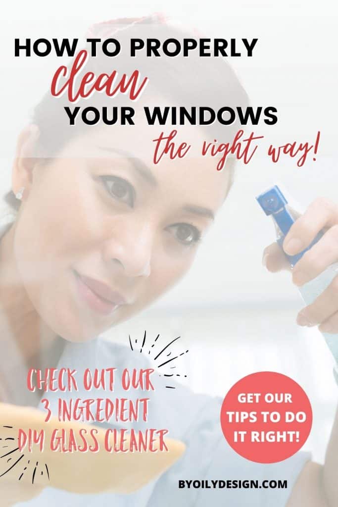 woman spraying a window with glass cleaner