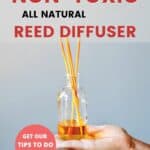 hand holding out a DIY reed diffuser